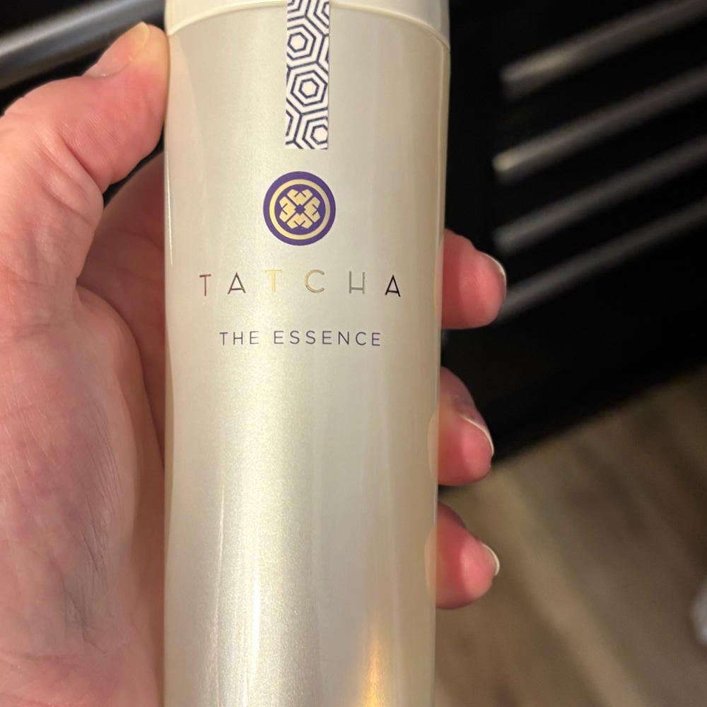 Tatcha The Essence Bottle — Pearl White with Purple and Gold Accents